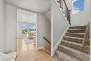 Stairway featuring wood finished floors and baseboards