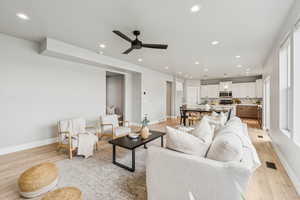 Living area featuring light wood finished floors, recessed lighting, and ceiling fan