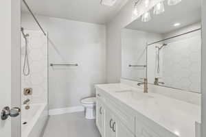 Bathroom featuring vanity,  shower combination, and light tile patterned floors