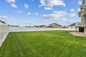 Fenced backyard featuring a residential view