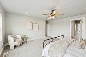 Carpeted bedroom with recessed lighting and ceiling fan