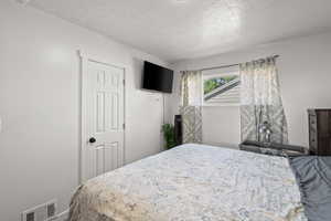 Bedroom with a textured ceiling