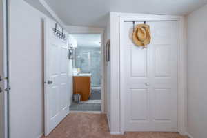 Bathroom with a marble finish shower, vanity, and a closet