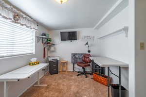 Office area with light colored carpet and a textured ceiling