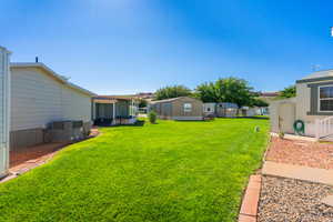 View of green lawn with a storage shed