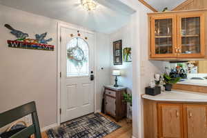 Foyer featuring a textured ceiling and light wood-type flooring