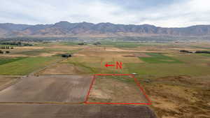 Aerial view of sparsely populated area featuring a mountain backdrop and property boundaries highlighted