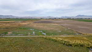 Aerial view of property's location with rural landscape and a mountain backdrop