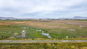 Overview of rural landscape with a mountain backdrop and agricultural land