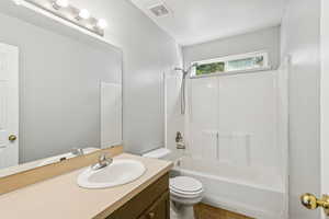 Bathroom with bathing tub / shower combination, vanity, and tile patterned floors