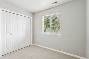 Unfurnished bedroom featuring carpet floors and a closet