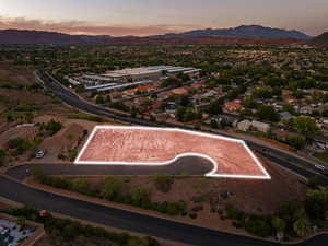 Aerial view at dusk of property boundaries highlighted, a mountain view, and a residential view