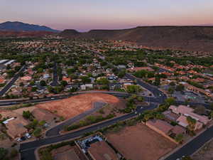 Aerial view of property's location with nearby suburban area and mountains