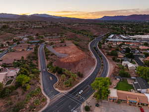 Aerial view of property's location with a mountain backdrop and nearby suburban area