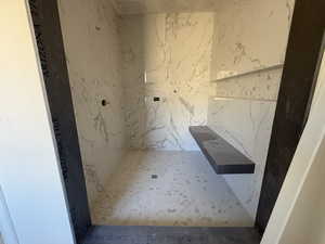 Bathroom with a marble finish shower