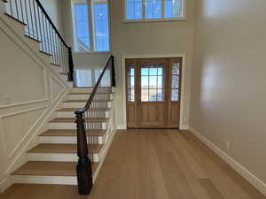 Entrance foyer with a high ceiling and light wood finished floors