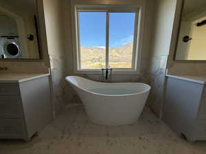 Bathroom featuring vanity, a freestanding tub
