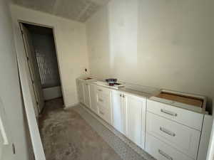 Bathroom featuring vanity and concrete floors