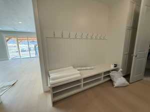 Mudroom featuring light wood-style floors and recessed lighting