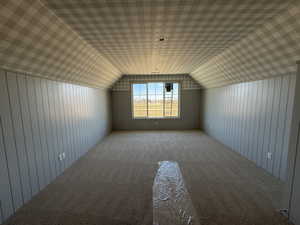 Bedroom featuring carpet floors and wooden walls