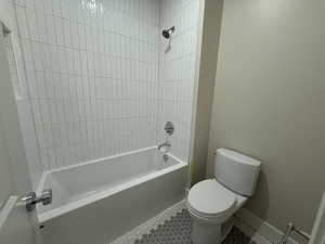 Bathroom with tub / shower combination and tile patterned floors