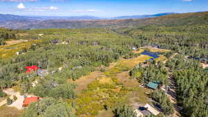 View of property location featuring a forest and a mountainous background