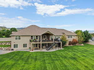 Back of property featuring stairs, a patio area, stucco siding, roof with shingles, and a deck