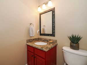 Half bath featuring vanity and toilet