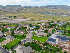 Aerial view of property's location with nearby suburban area and a mountain backdrop