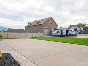 View of patio / terrace featuring concrete driveway and a garage