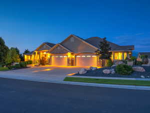 Craftsman-style house featuring concrete driveway, an attached garage, and stucco siding