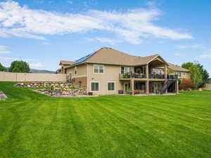 Rear view of house with a patio, stairway, stucco siding, and a fenced backyard