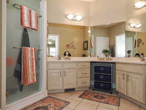 Bathroom featuring light tile patterned flooring and vanity