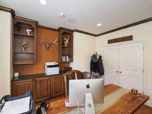 Office space with ornamental molding and recessed lighting
