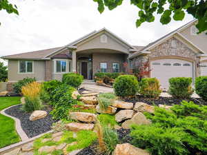 View of front of home with covered porch and stucco siding