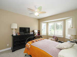 Bedroom with carpet flooring and a ceiling fan