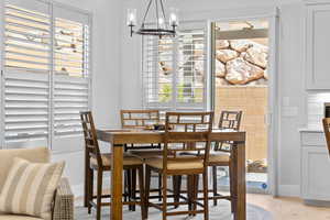 Dining area with a chandelier and light wood-style flooring