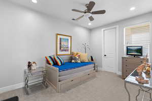 Bedroom with light colored carpet, ceiling fan, and recessed lighting