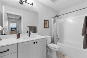Bathroom featuring shower / bathtub combination with curtain and vanity