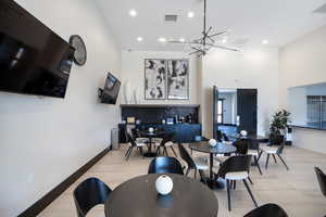 Dining room with recessed lighting and a chandelier