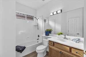 Bathroom with  shower combination, vanity, and dark wood-style floors