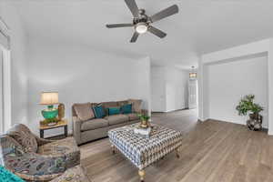 Living area with wood finished floors and ceiling fan