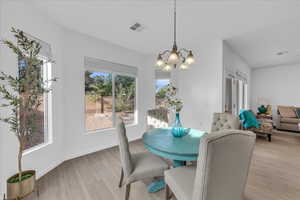 Dining area featuring light wood-style floors and a chandelier