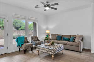 Living area featuring light wood-style flooring and a ceiling fan