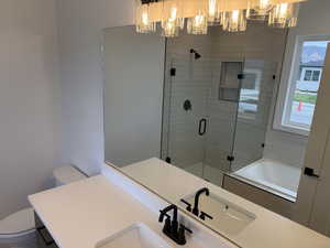 Full bath with a bath, vanity, and a shower stall