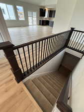 Staircase featuring wood finished floors