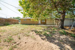 Back of house with brick siding and a patio area