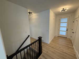 Foyer featuring light wood-style floors and a textured ceiling