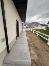 View of side of property with a mountain view and stucco siding