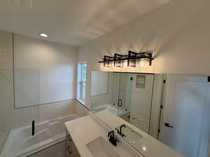 Full bathroom with vanity, a bath, a shower stall, and recessed lighting